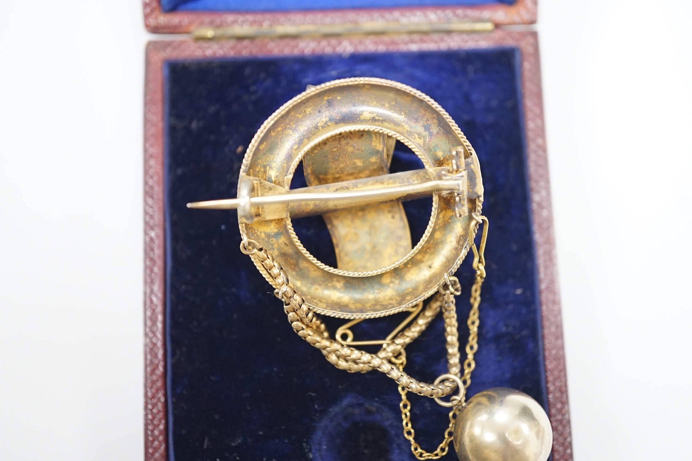 A Victorian gilt white metal drop brooch, with central buckle motif and spherical drop, 80mm, in fitted leather case.